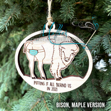 Load image into Gallery viewer, 2021 Covid Mask Ornament: Putting it all behind us, Bison / Buffalo version | Wooden Christmas ornament | Masks on Butt
